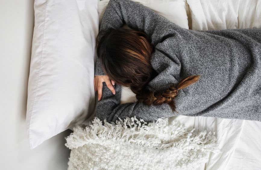 A woman napping restlessly.