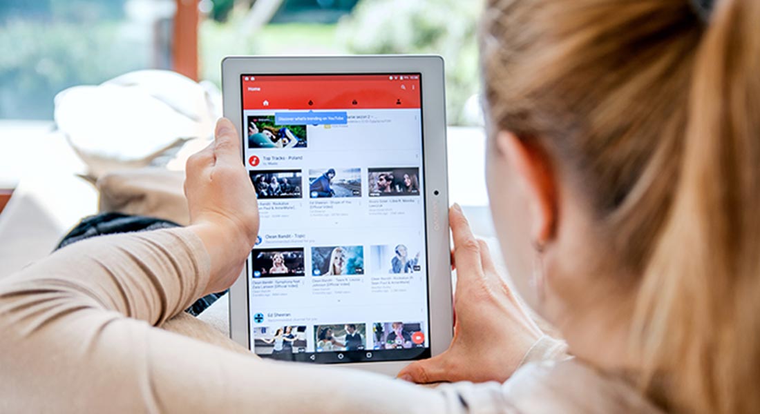 woman browsing YouTube on tablet