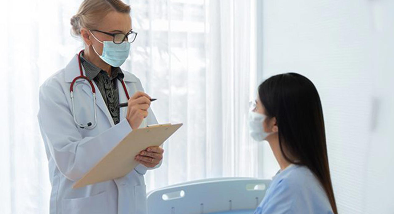 female doctor with patient in hospital room