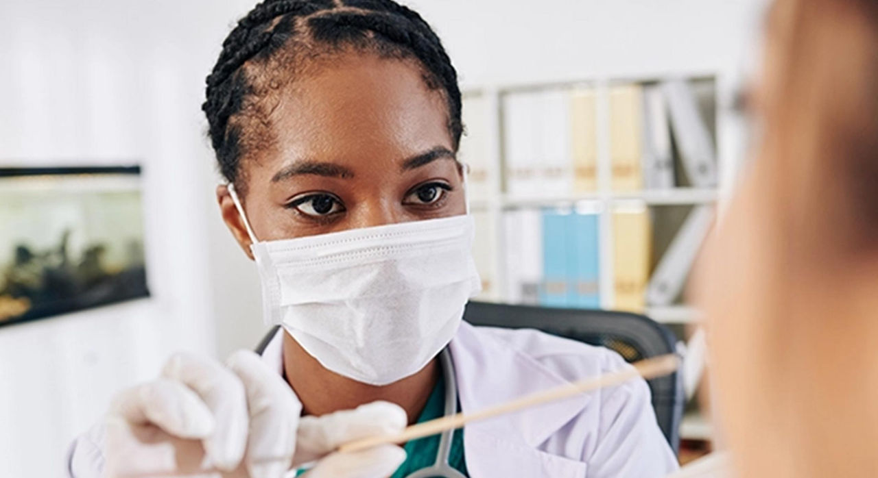 healthcare worker using swab on patient