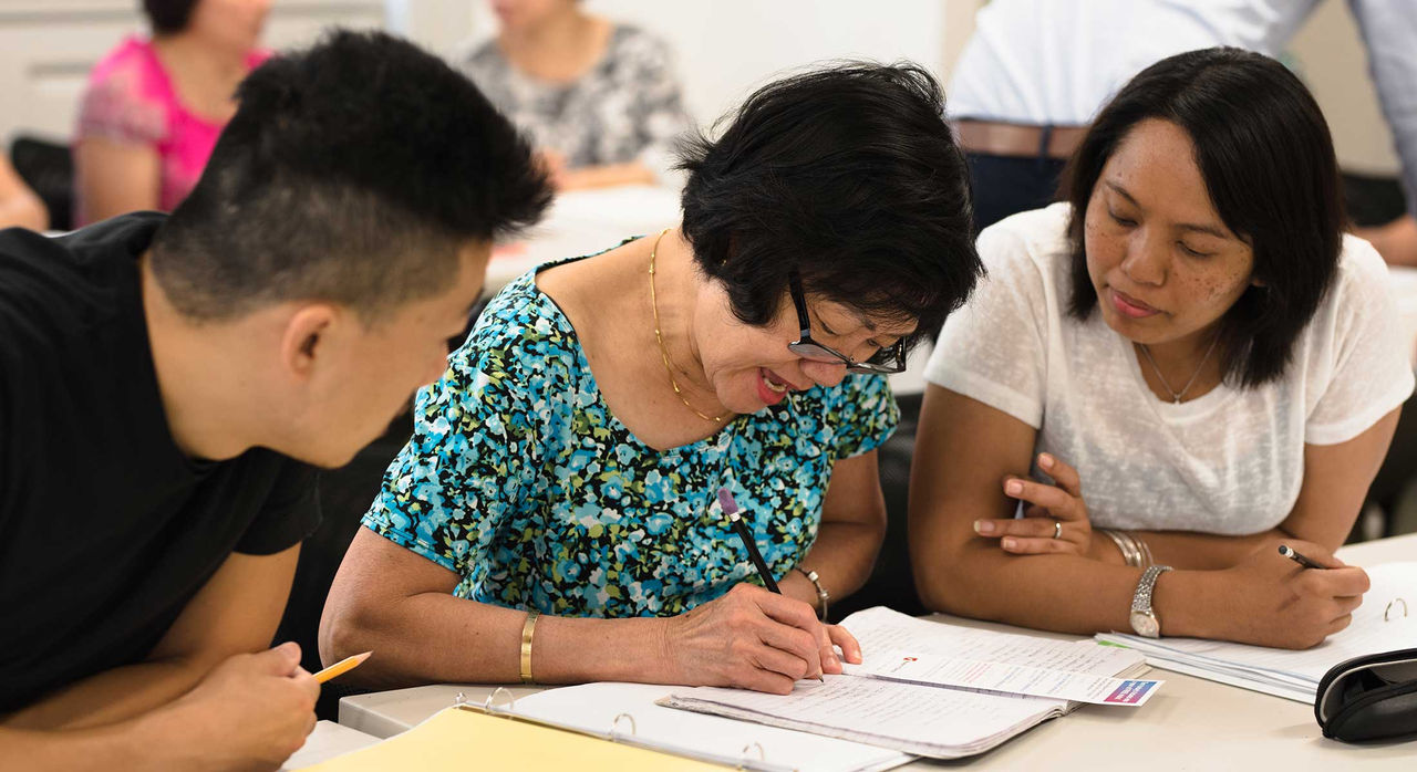 Recent immigrants studying together.