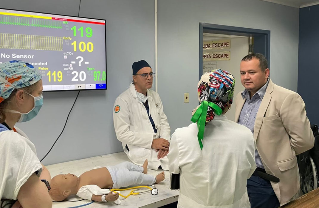 Members of the Careways Collaborative in an examining room, training on a model of a toddler.