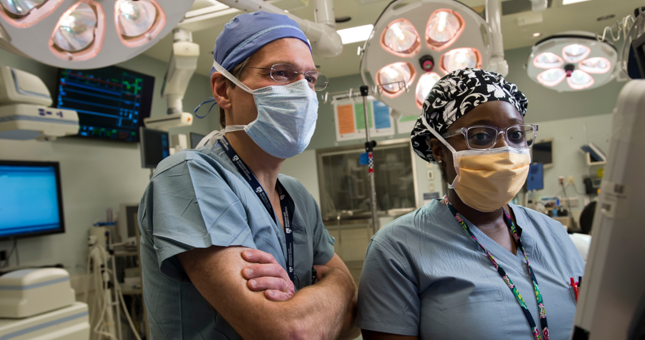 doctor and trainee in operating room at monitor