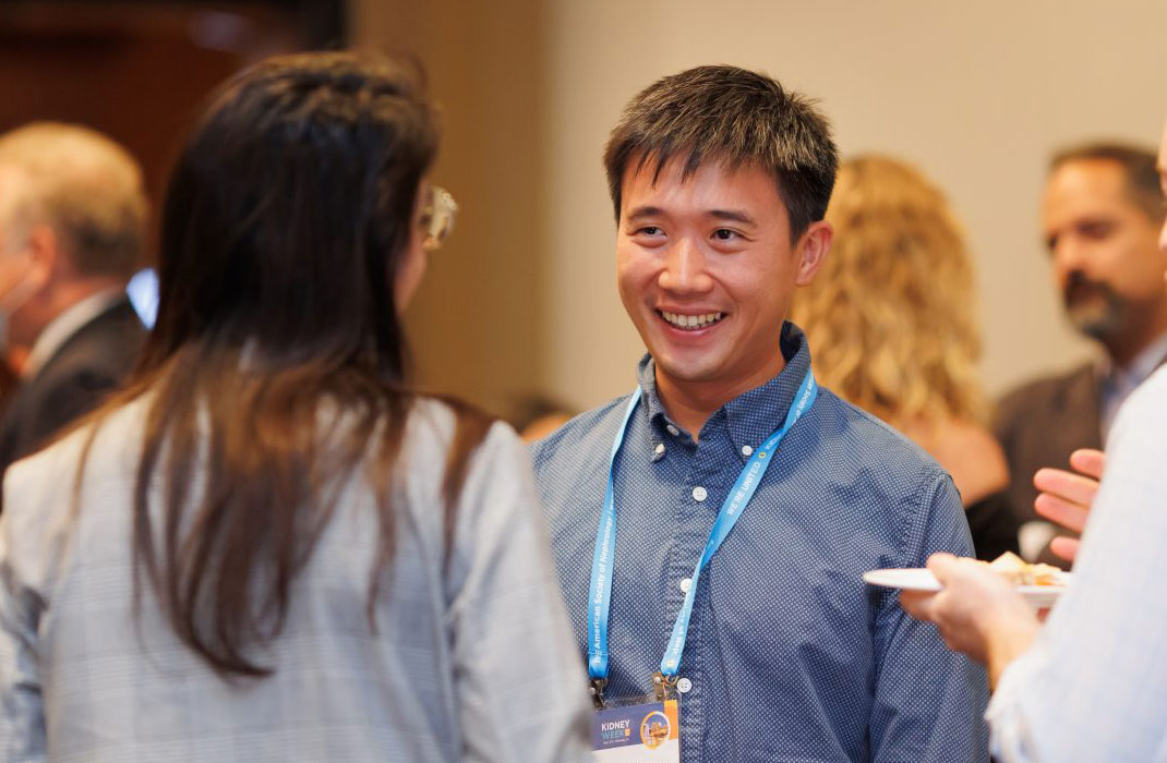 man and woman talking at an event