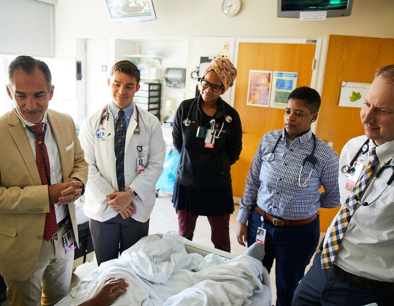 providers and clinical trainees at a patient's bedside