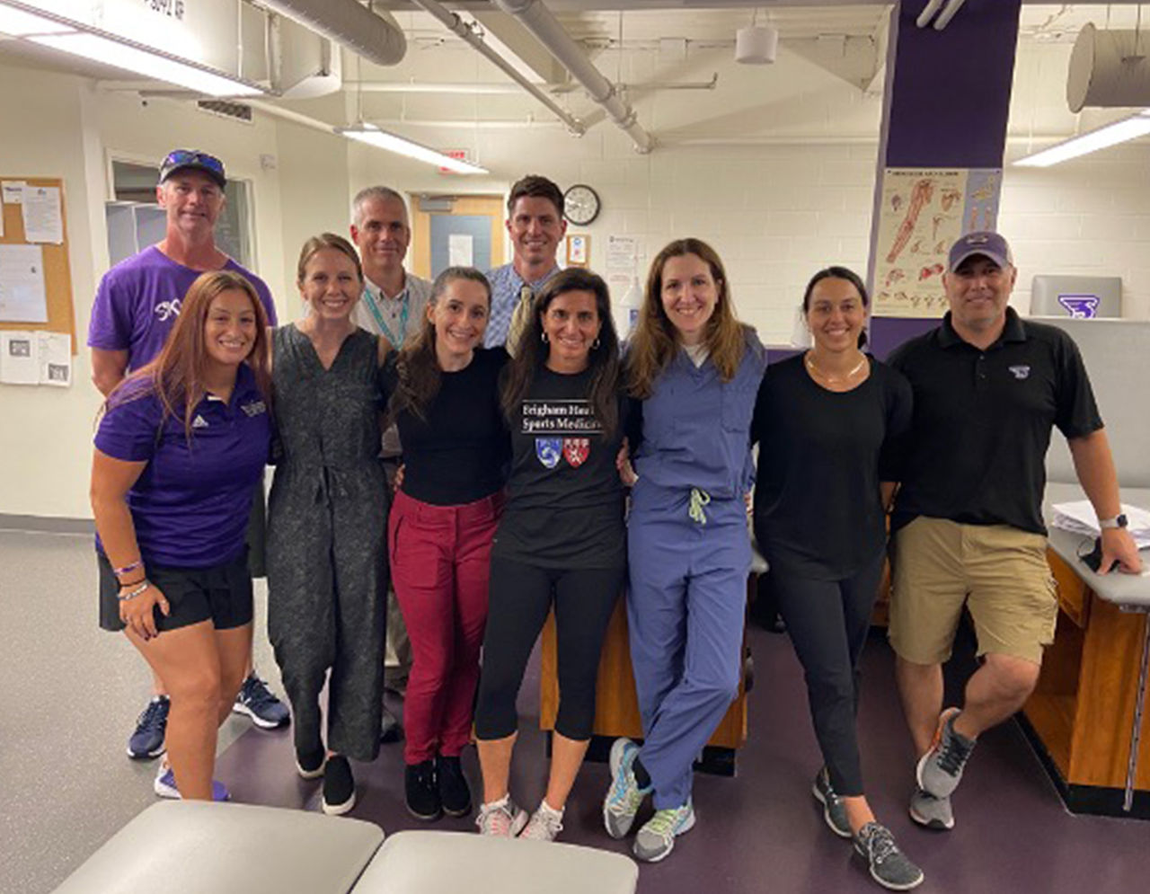 Liz Matzkin and Gio Medina pose with fellows at Stonehill College.