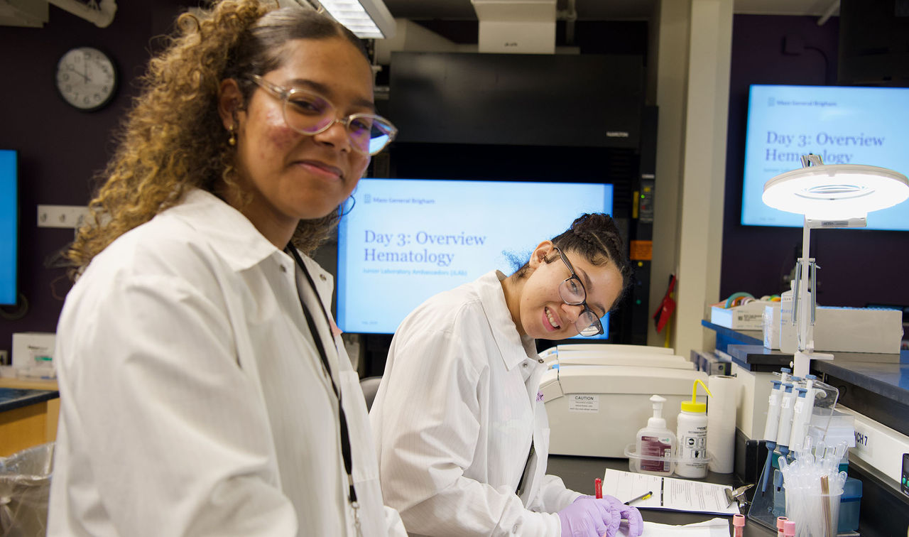 two female students smiling in lab