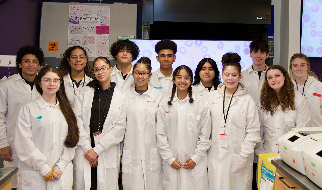 group of students wearing lab coats 