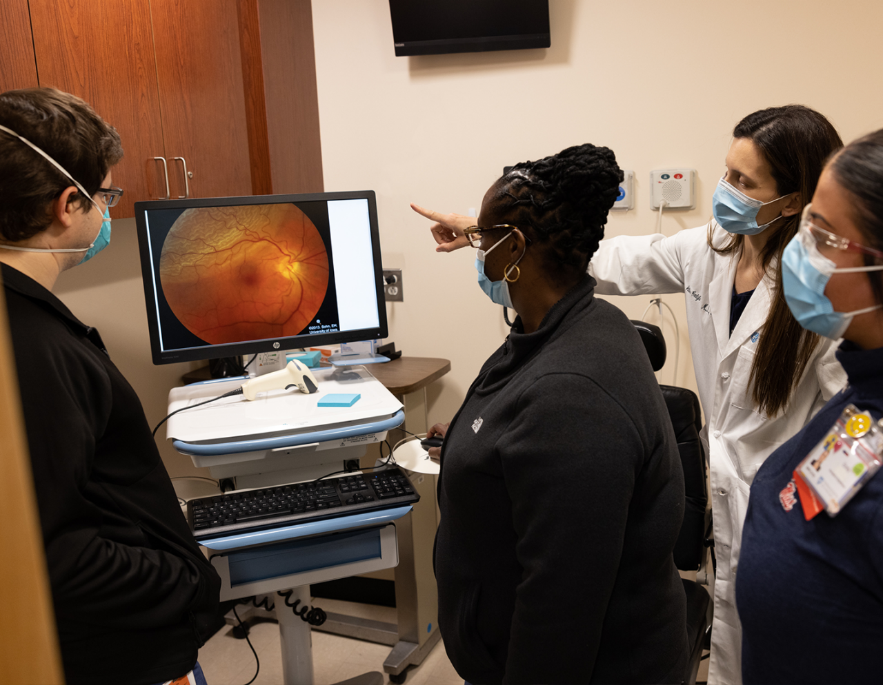 group of clinician and staff viewing a medical image on a monitor