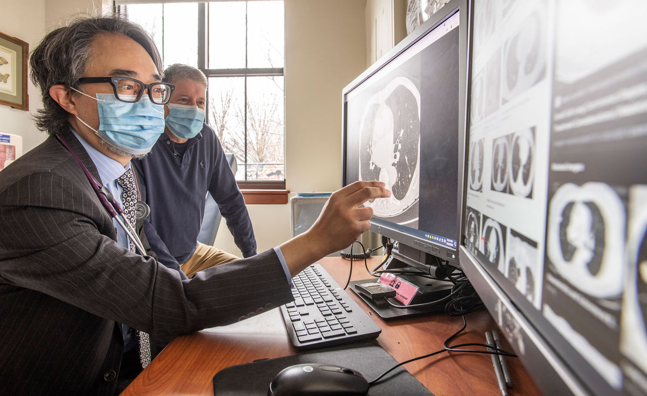 Doctors looking at scans on computer screens