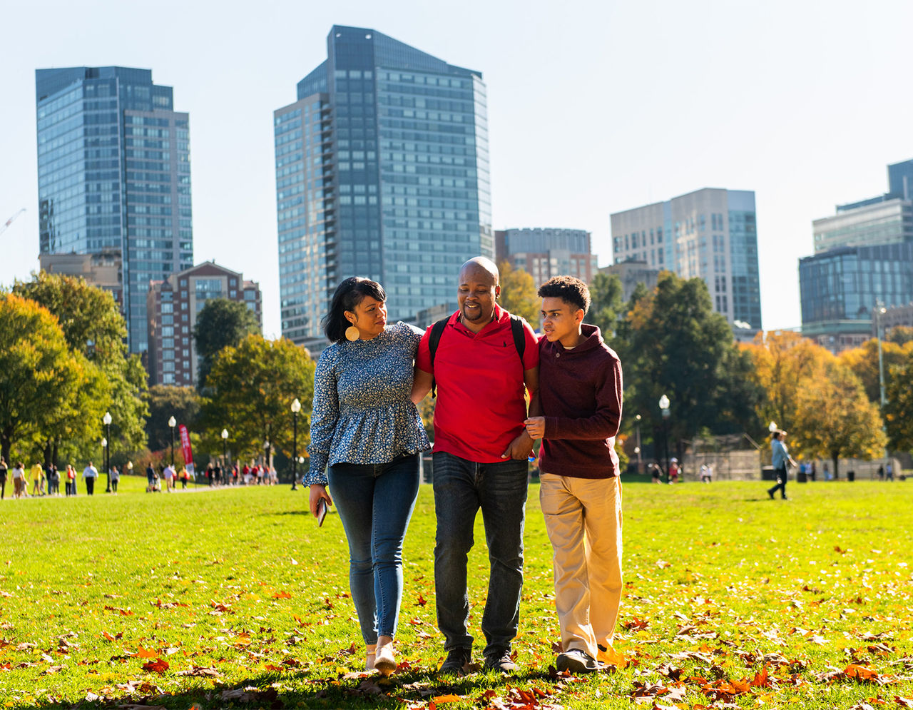 Family walking in Boston Commons in fall