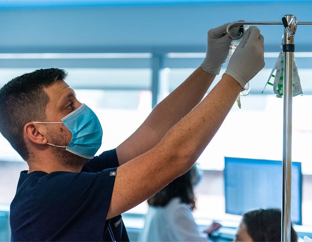 Male provider setting up IV bag 