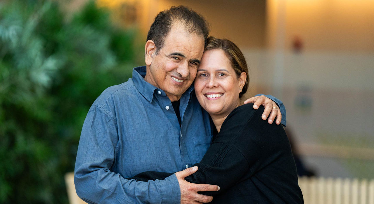 Husband and wife hugging and smiling together