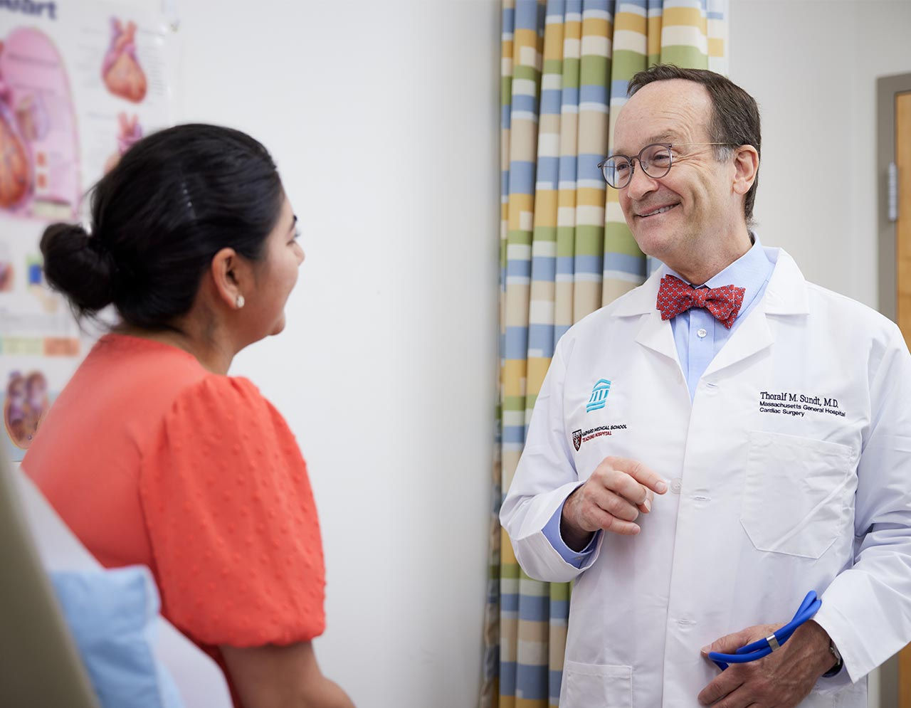 Dr. Thor Sundt speaks with a patient in an exam room