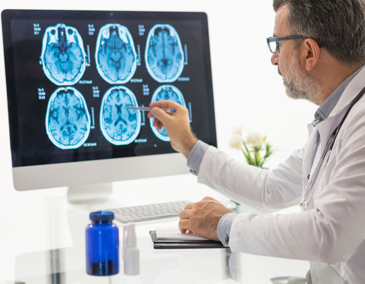 Male doctor examining brain MRI scans