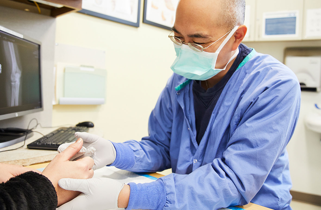 male provider examining a patient's hand