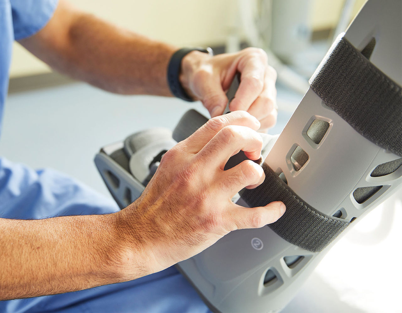 Provider adjusting a patient’s foot brace 
