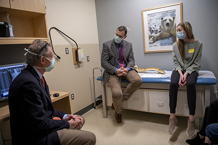 Meg Armstrong meets with care team during a follow-up visit after tethering surgery. 