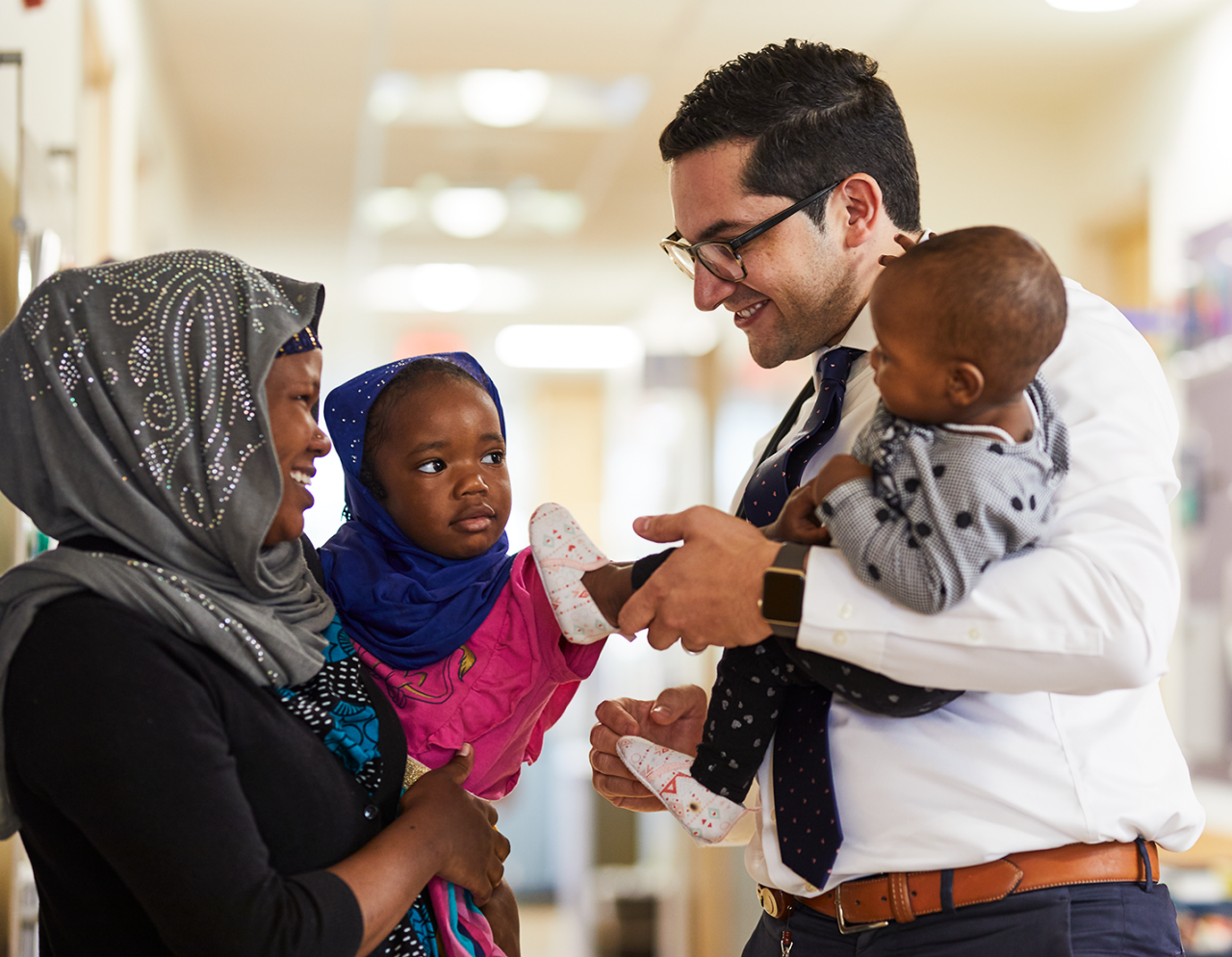 Dr. Carlos Torres smiling with family at MGH Healthcare Center in Chelsea 