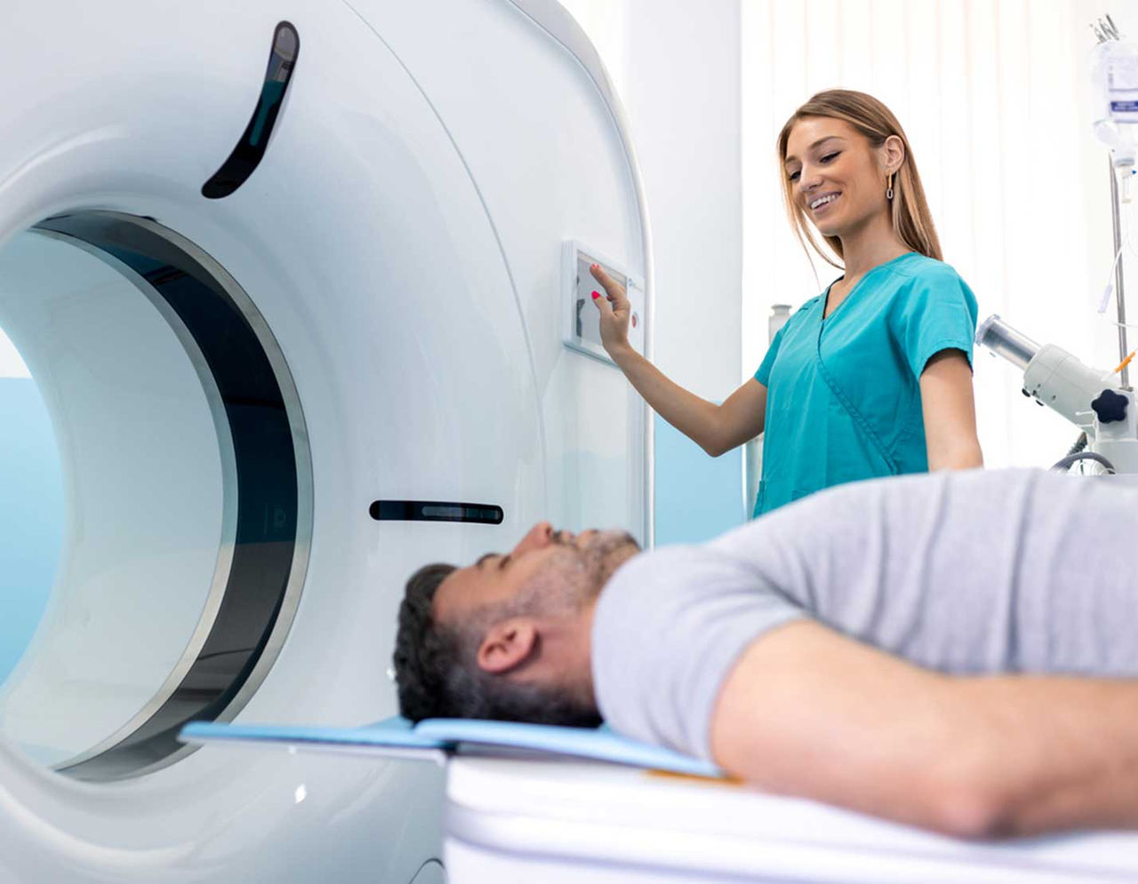 female clinician preparing a man for an MRI
