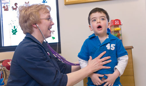 female doctor examining young boy patient