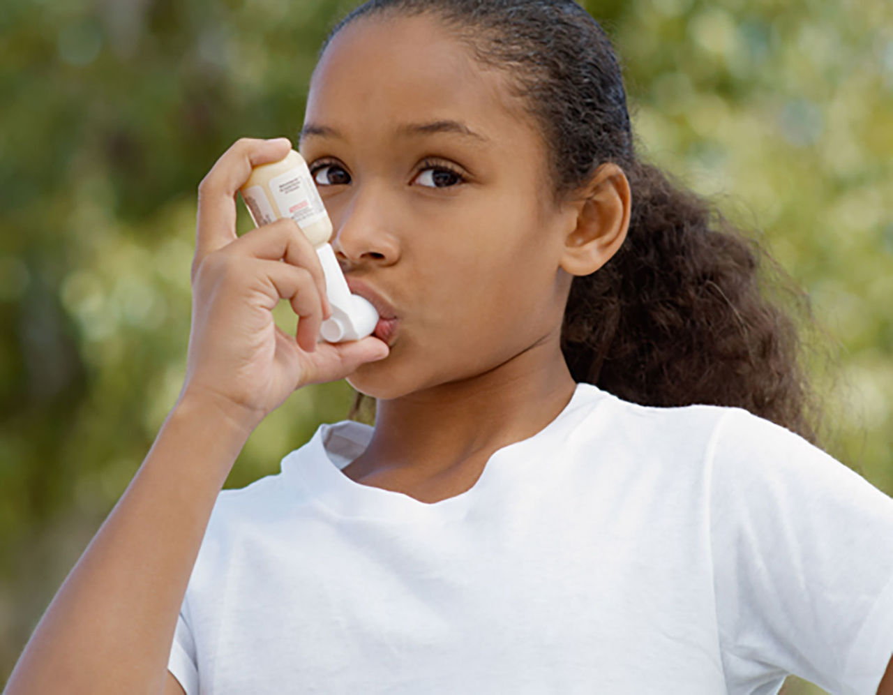 Girl using inhaler