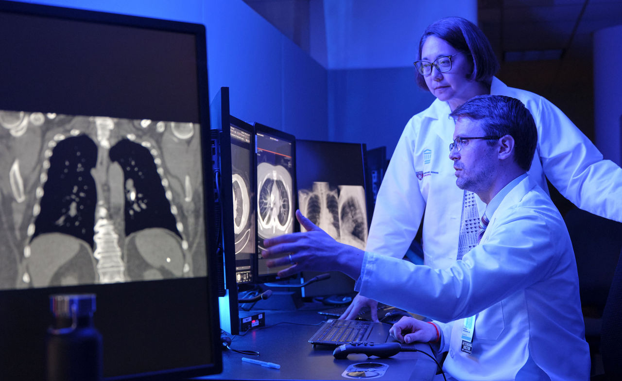 Lecia Sequist, MD and Florian Fintelmann, MD looking at a lung scan on a monitor.