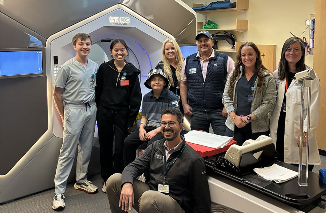 Remy and his dad with care team members from the Mass General Brigham Cancer Institute