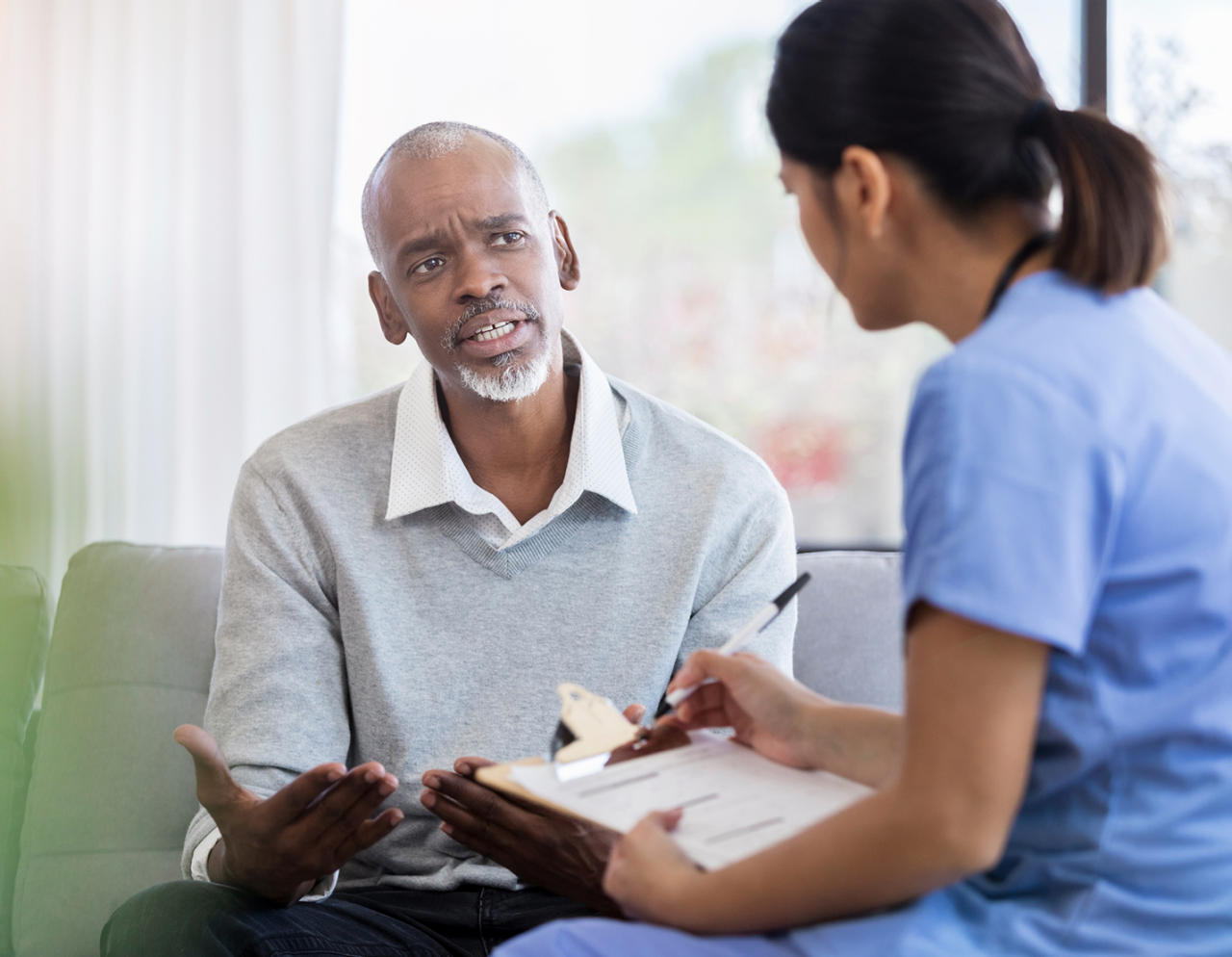 clinician talking with a patient in waiting room