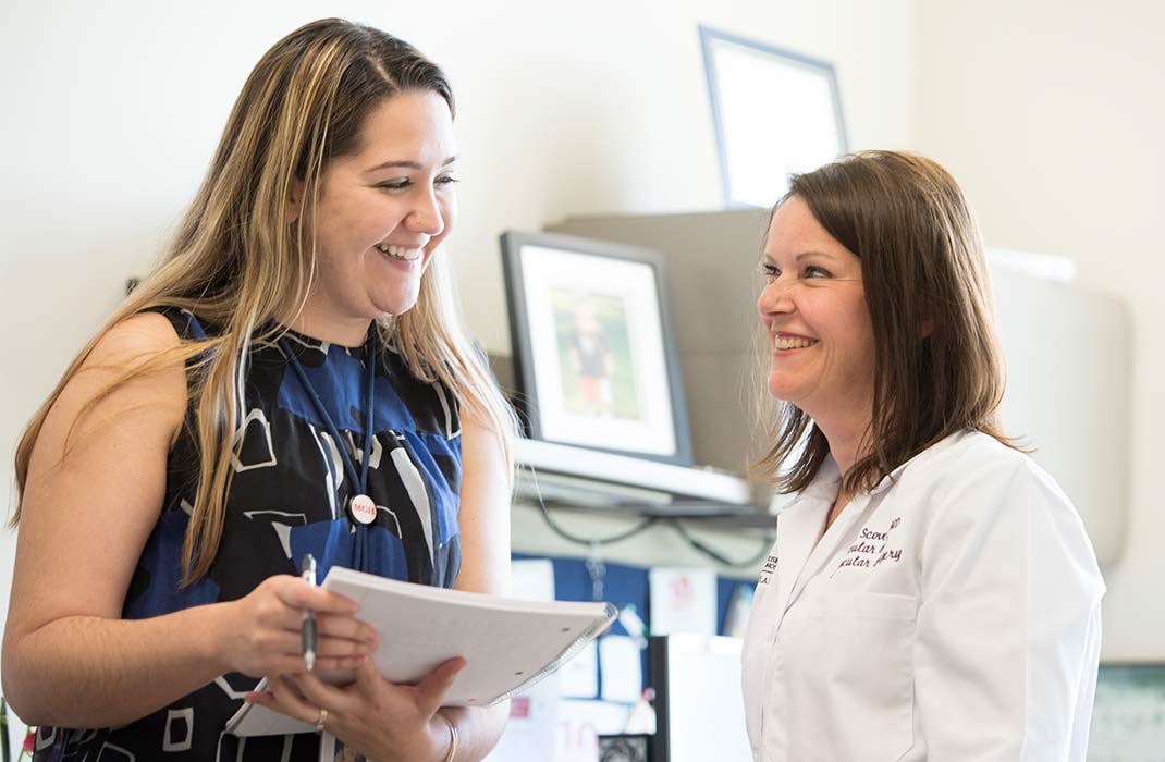 two female providers smiling in office