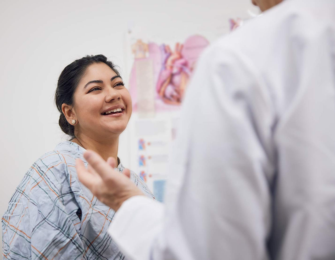 female heart patient talking to provider in exam room