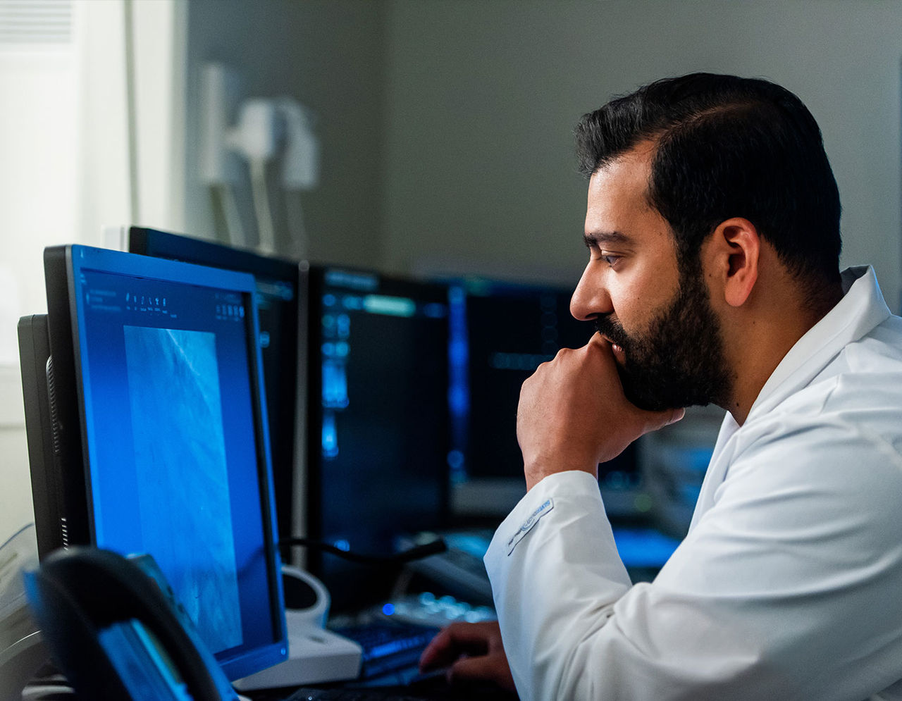 male heart provider at computer viewing images on monitor