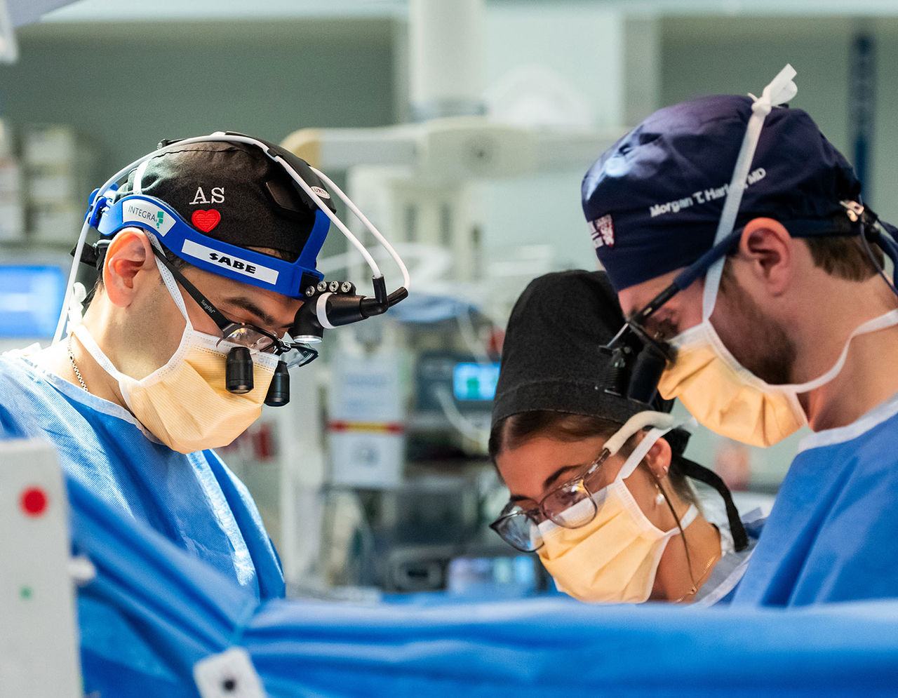 close up of heart providers performing surgery on patient in operating room