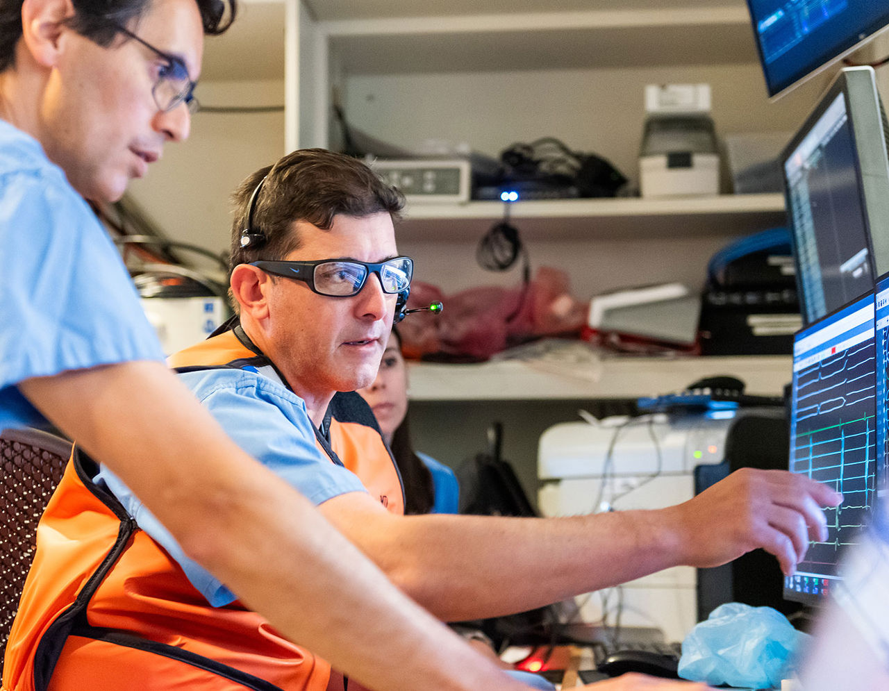 members of the heart care team viewing patient data at monitors