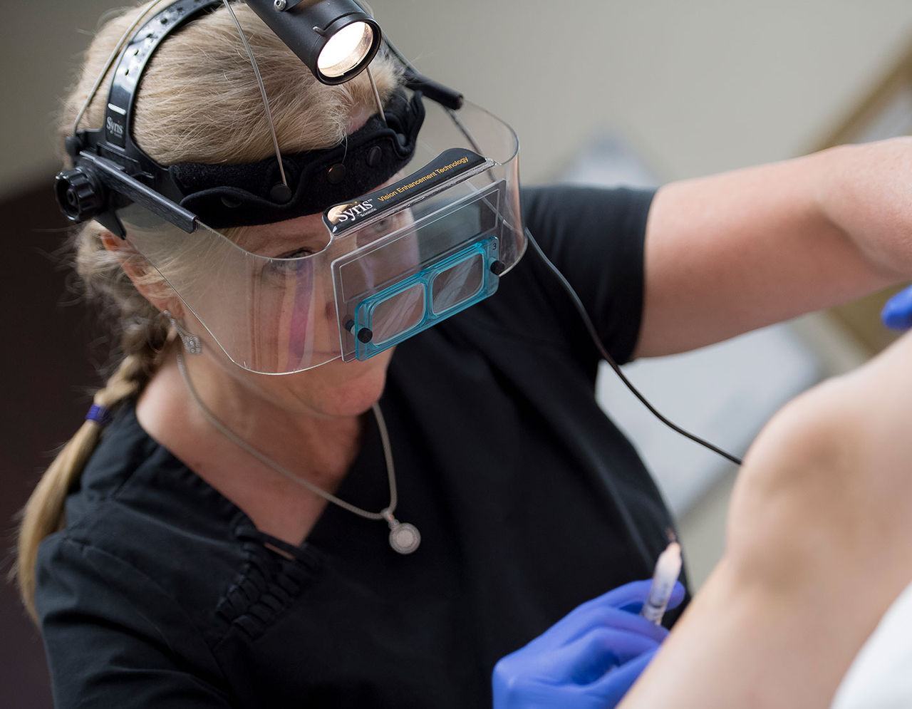 vascular doctor performing procedure on patient