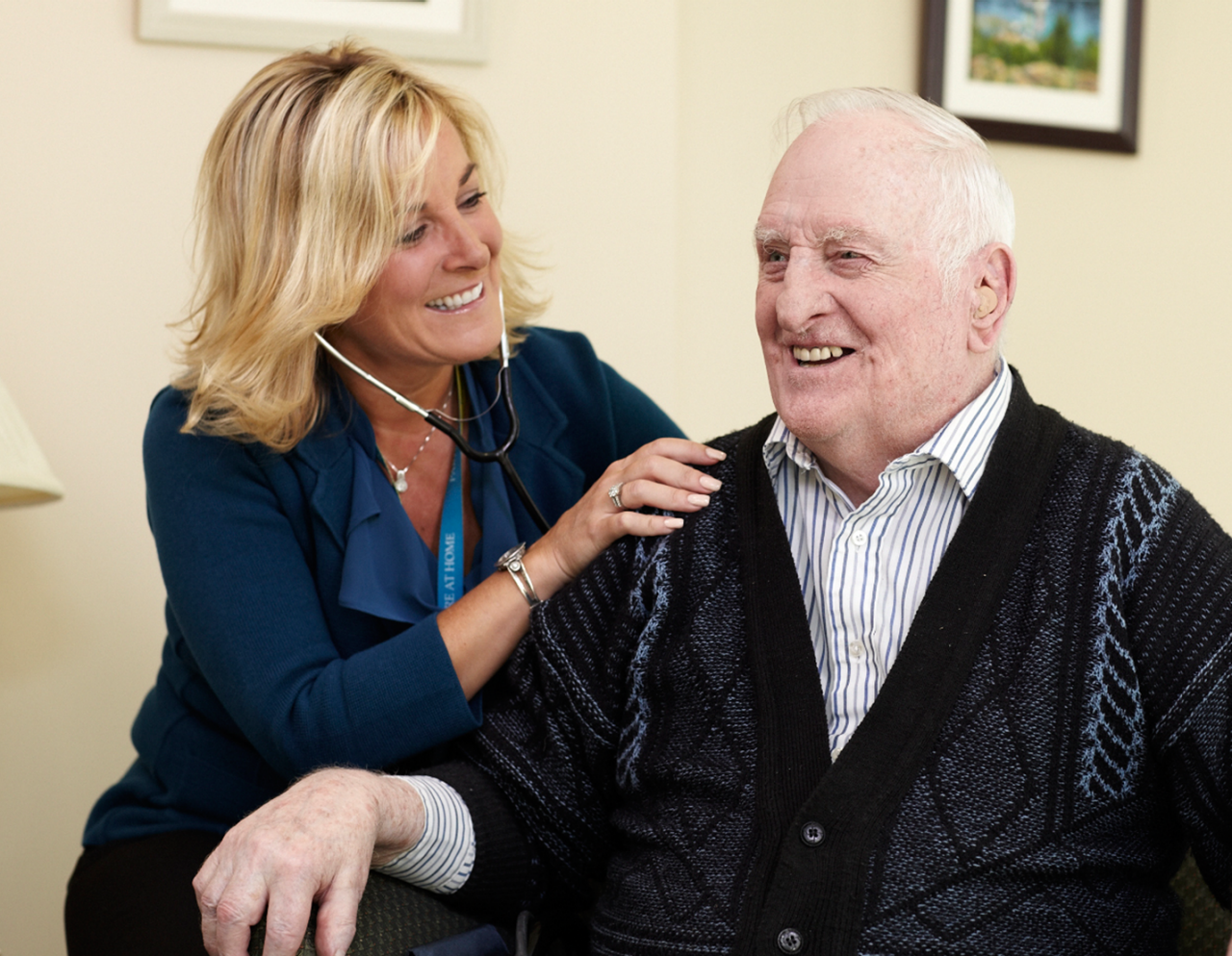 female provider examining senior male patient