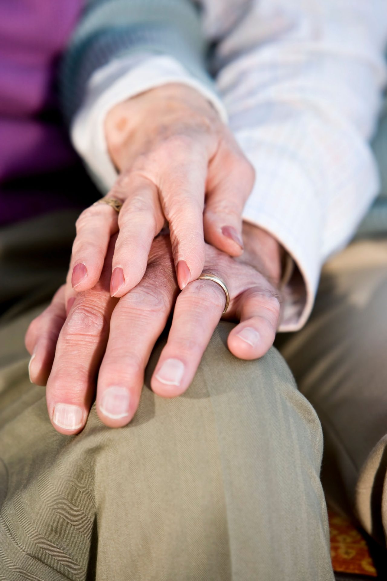 two patients holding hands