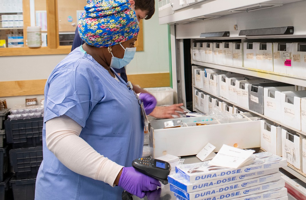 two pharmacy techs preparing prescriptions in pharmacy