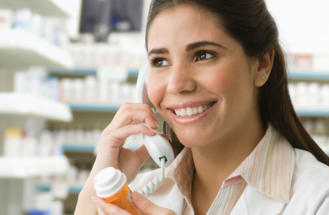 two pharmacy techs preparing prescriptions in pharmacy