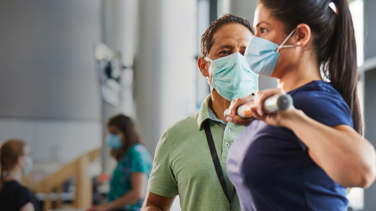 male provider performing exercise with female patient