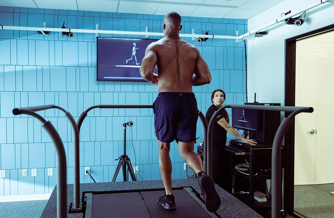 male athlete running undergoing a running assessment on treadmill