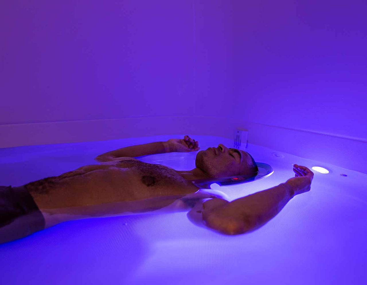 male athlete laying in floatation tank