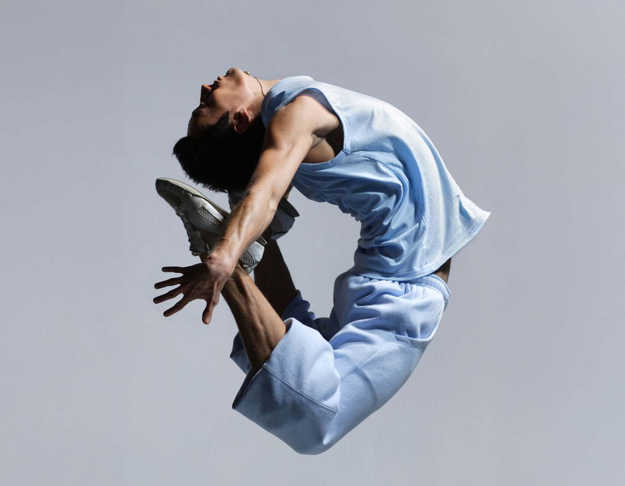 Athlete performing dynamic mid-air dance leap