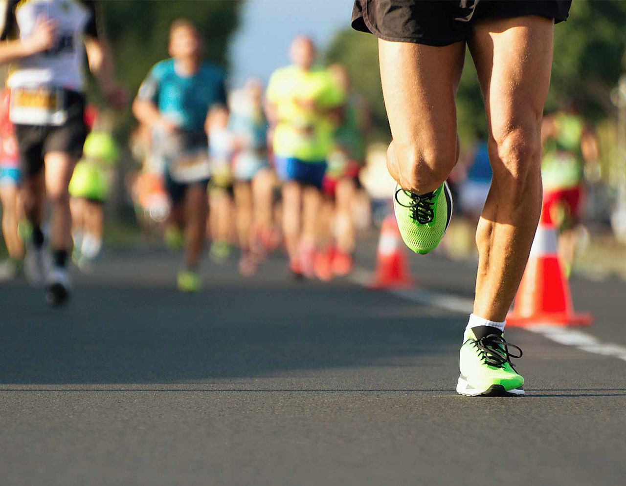 close up of runners' legs during road race