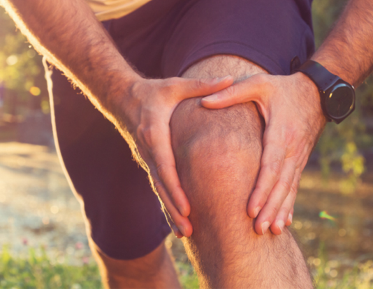 man holding his knee with both hands