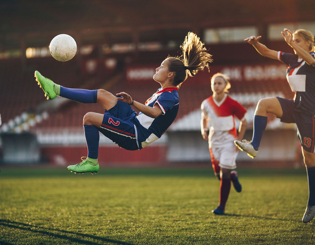 female soccer players in action during game