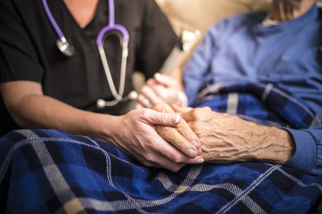 Provider holding hands of a patient
