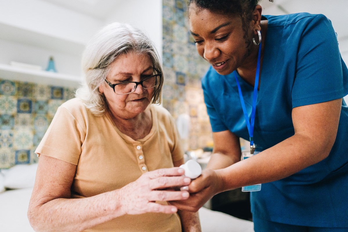 Patient and doctor looking at prescription bottle