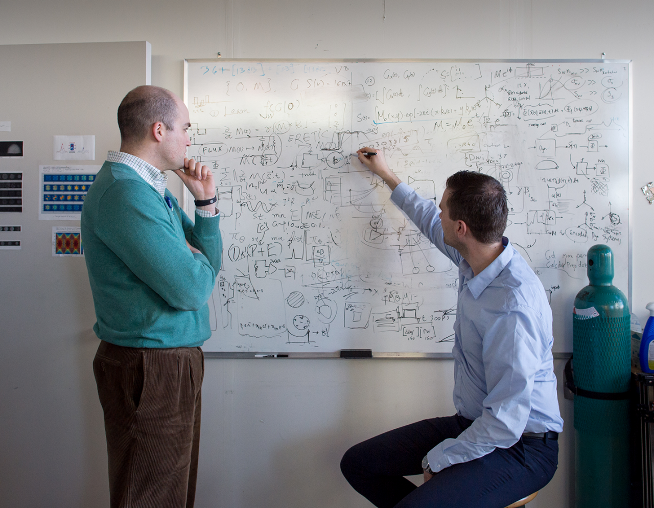 Male researchers at a white board 
