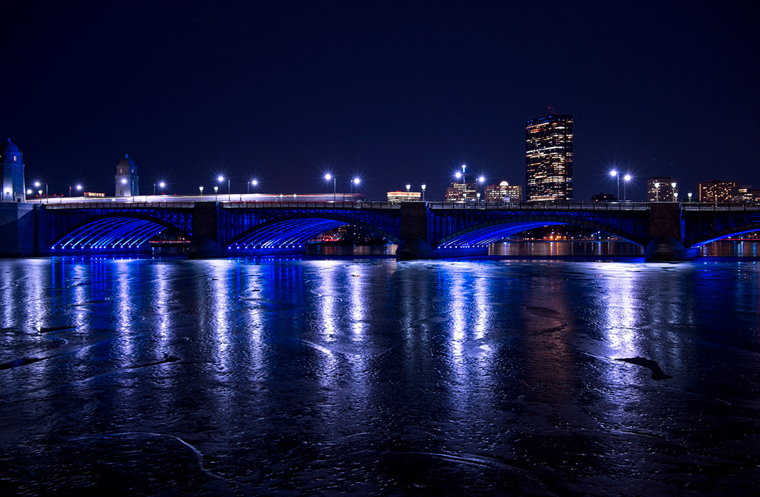 Nighttime view of Boston skyline and Charles River